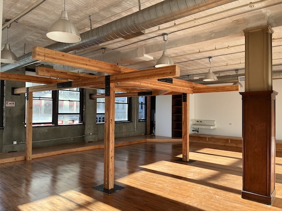 Our studio space, featuring hardwood floors, a large wooden suspension frame, and huge east-facing windows for great morning light